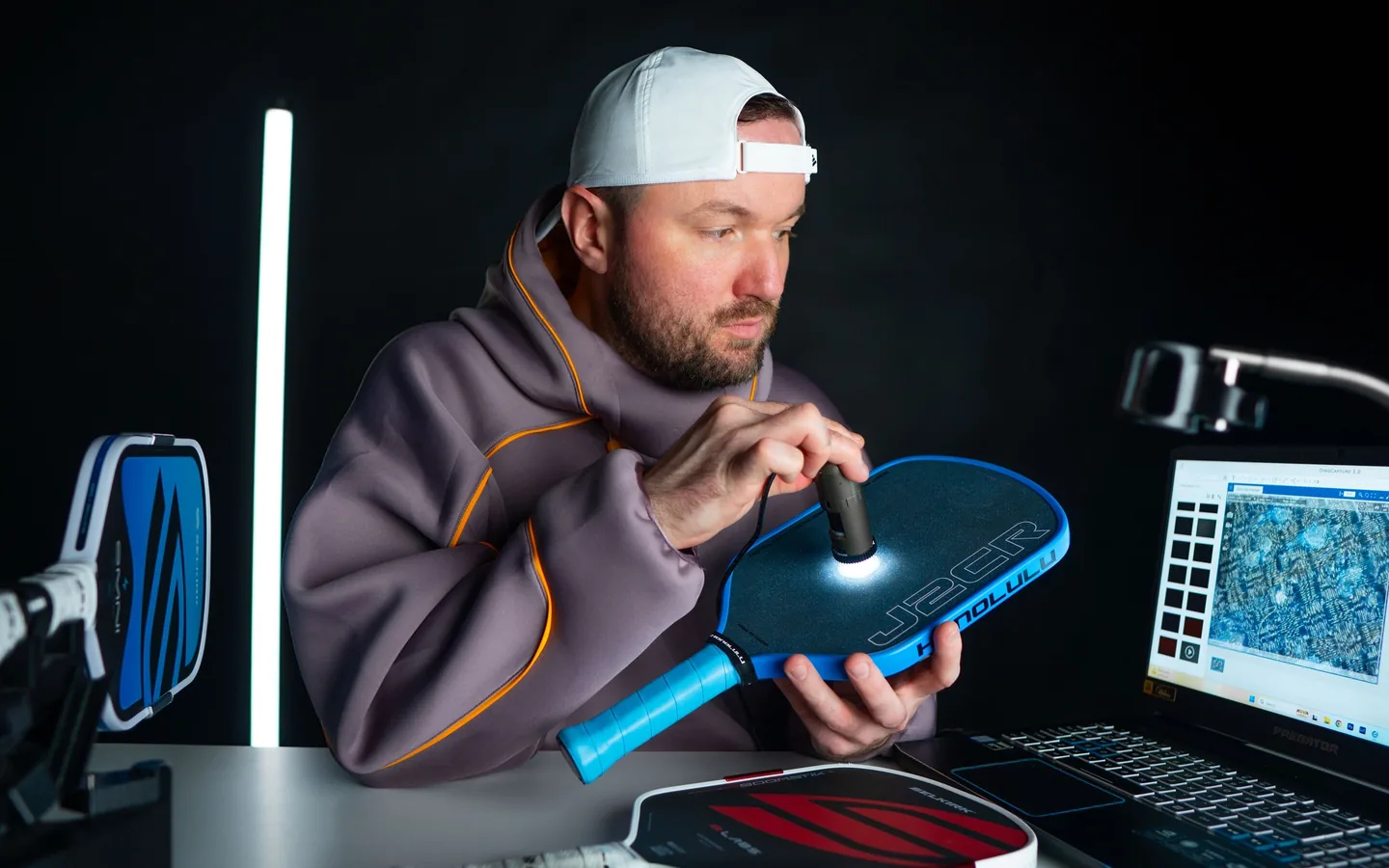 Steven inspecting a paddle face under a digital microscope